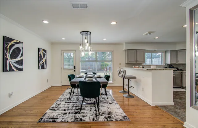 a living room with kitchen island furniture and a wooden floor