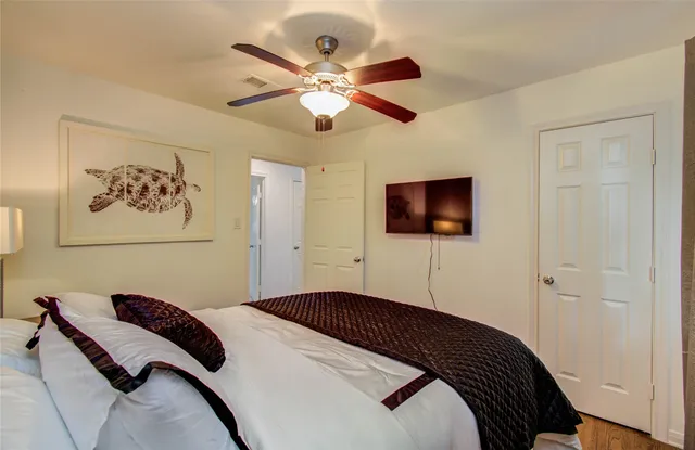 a bedroom with a bed and a flat screen tv