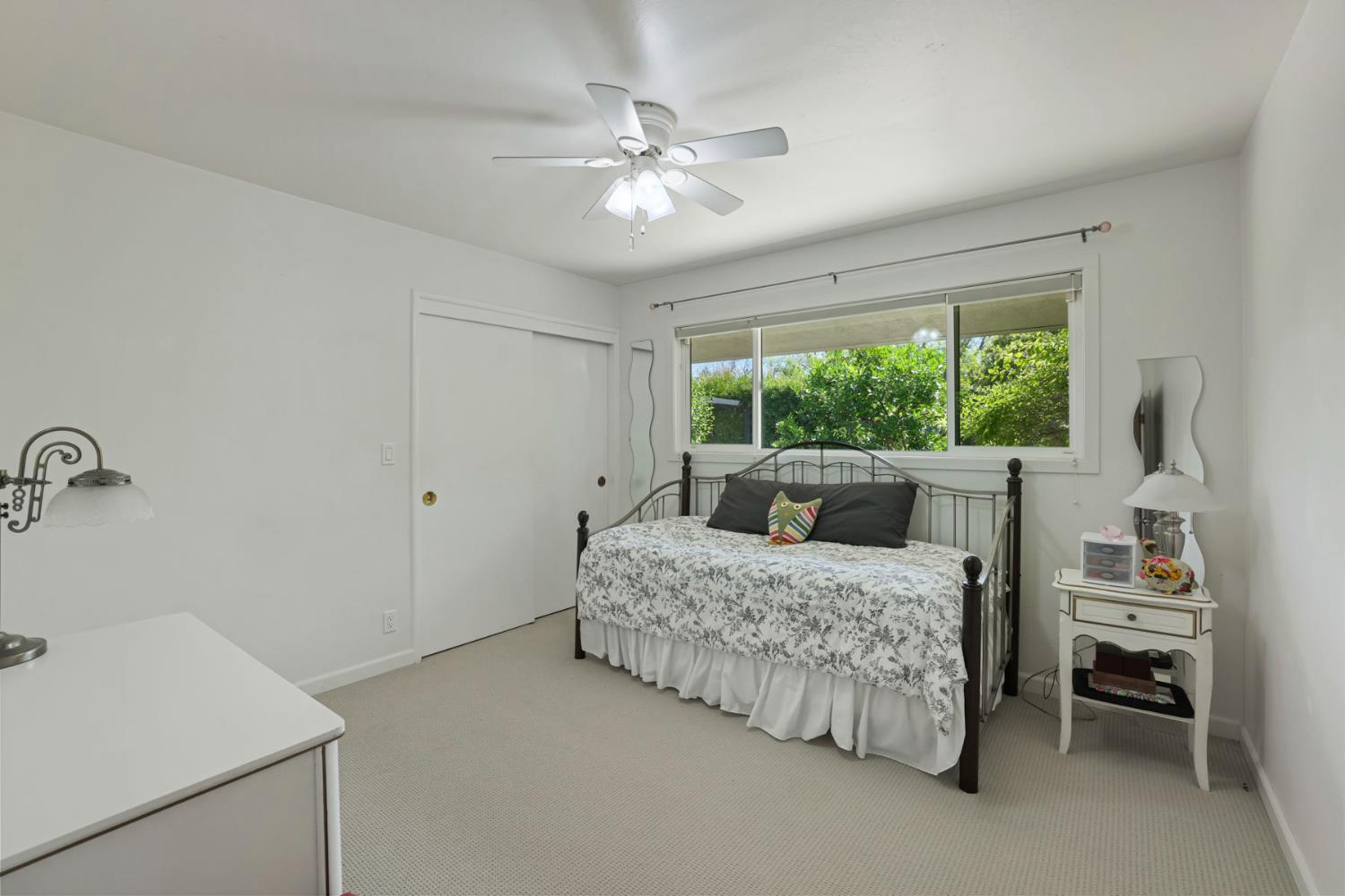 2406 Kenmore Court Modesto, CA 95350 - Photo 30 of 54 a room with a bed and a chandelier