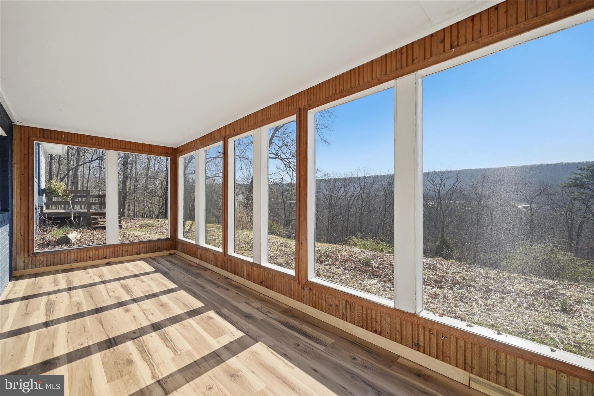 2280 Pine Grove Road Berkeley Springs, WV 25411 - Photo 38 of 59 a view of a large room with wooden floor and windows