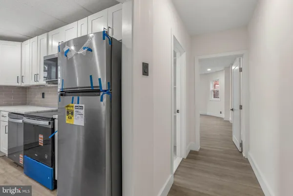a kitchen with stainless steel appliances a refrigerator and a stove