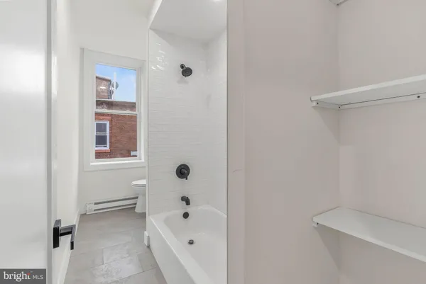 a bathroom with a bathtub and shower