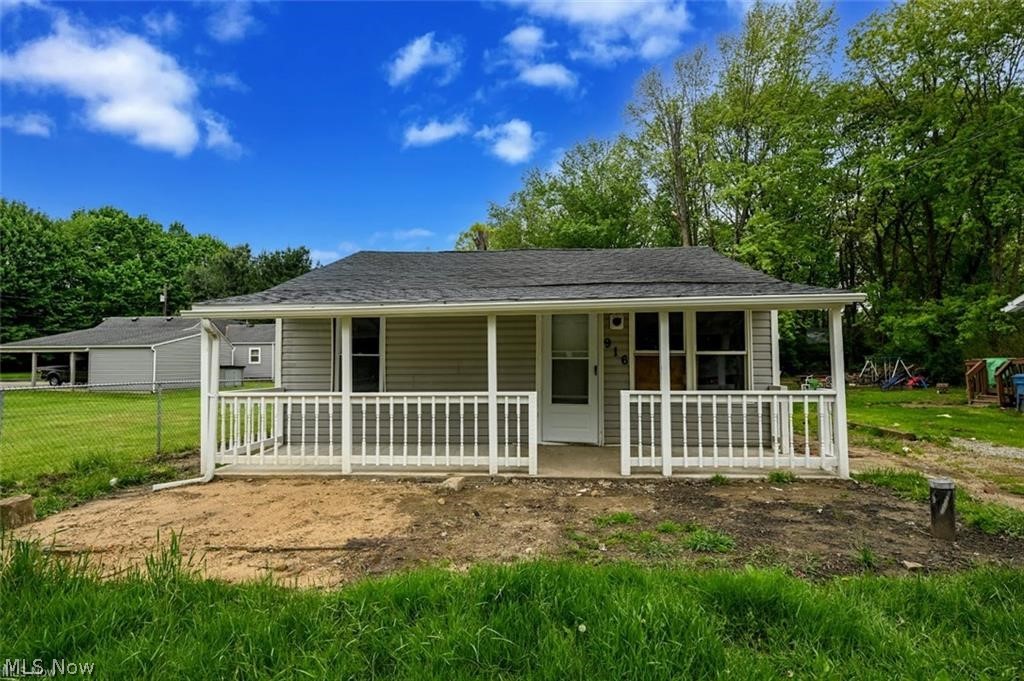 916 Abington Road Akron, OH 44312 - Photo 2 of 24 Front facade with light grey siding and a dark shingle roof