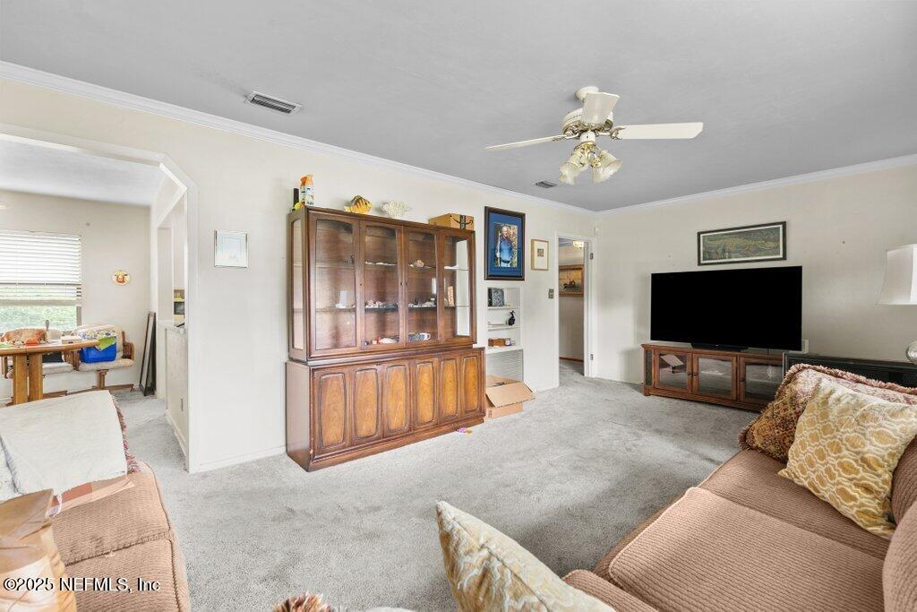 2305 Broward Road Jacksonville, FL 32218 - Photo 12 of 30 a living room with furniture and a flat screen tv