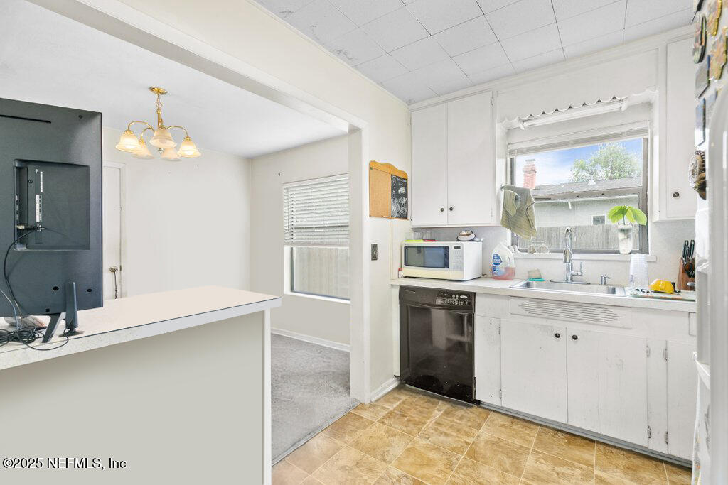 2305 Broward Road Jacksonville, FL 32218 - Photo 15 of 30 a kitchen with a sink stove and refrigerator