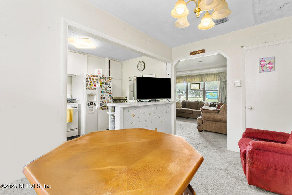 2305 Broward Road Jacksonville, FL 32218 - Photo 17 of 30 a living room with furniture and a flat screen tv