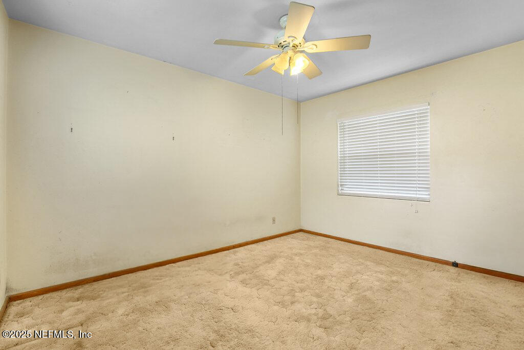 2305 Broward Road Jacksonville, FL 32218 - Photo 22 of 30 an empty room with a window and a ceiling fan