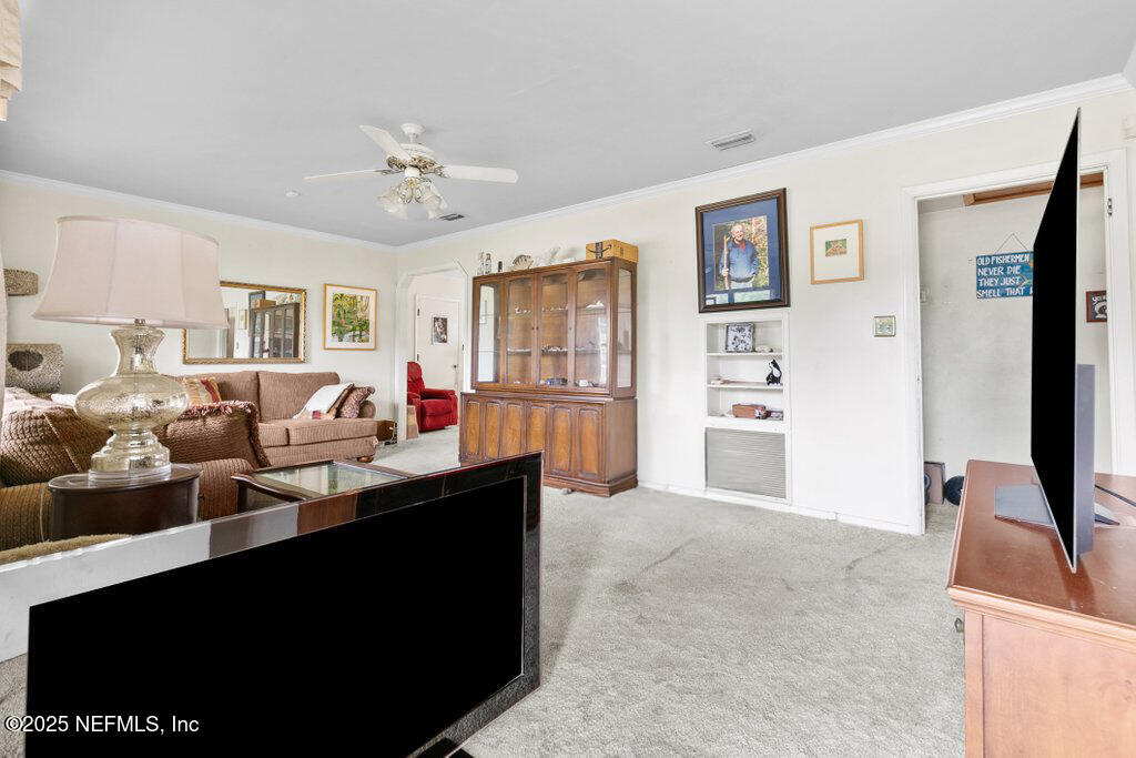2305 Broward Road Jacksonville, FL 32218 - Photo 9 of 30 a living room with furniture and a flat screen tv
