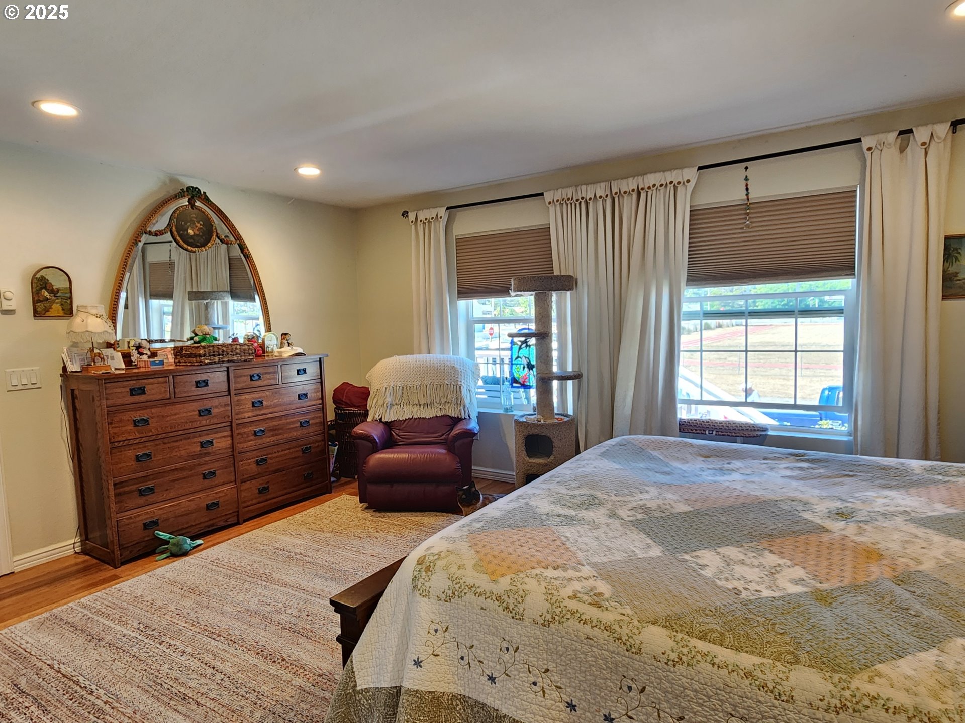1126 Washington Street Port Orford, OR 97465 - Photo 11 of 32 a bedroom with a bed and a dresser