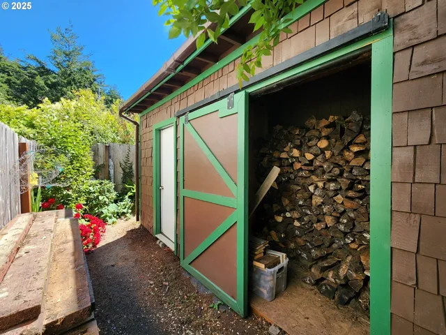 a backyard of a house with lots of green space and wooden fence