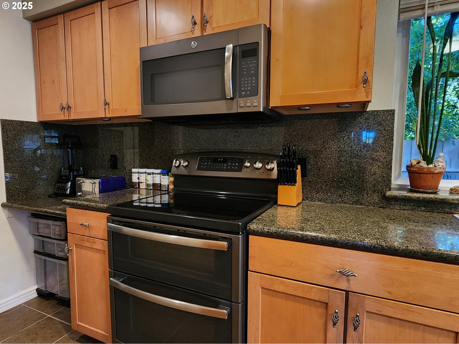 1126 Washington Street Port Orford, OR 97465 - Photo 8 of 32 a kitchen with stainless steel appliances granite countertop a stove and a microwave