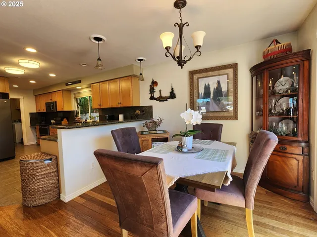 a view of a dining room with furniture wooden floor and chandelier