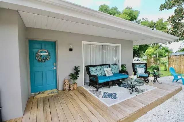 a kitchen with stainless steel appliances kitchen island granite countertop a table chairs sink and cabinets