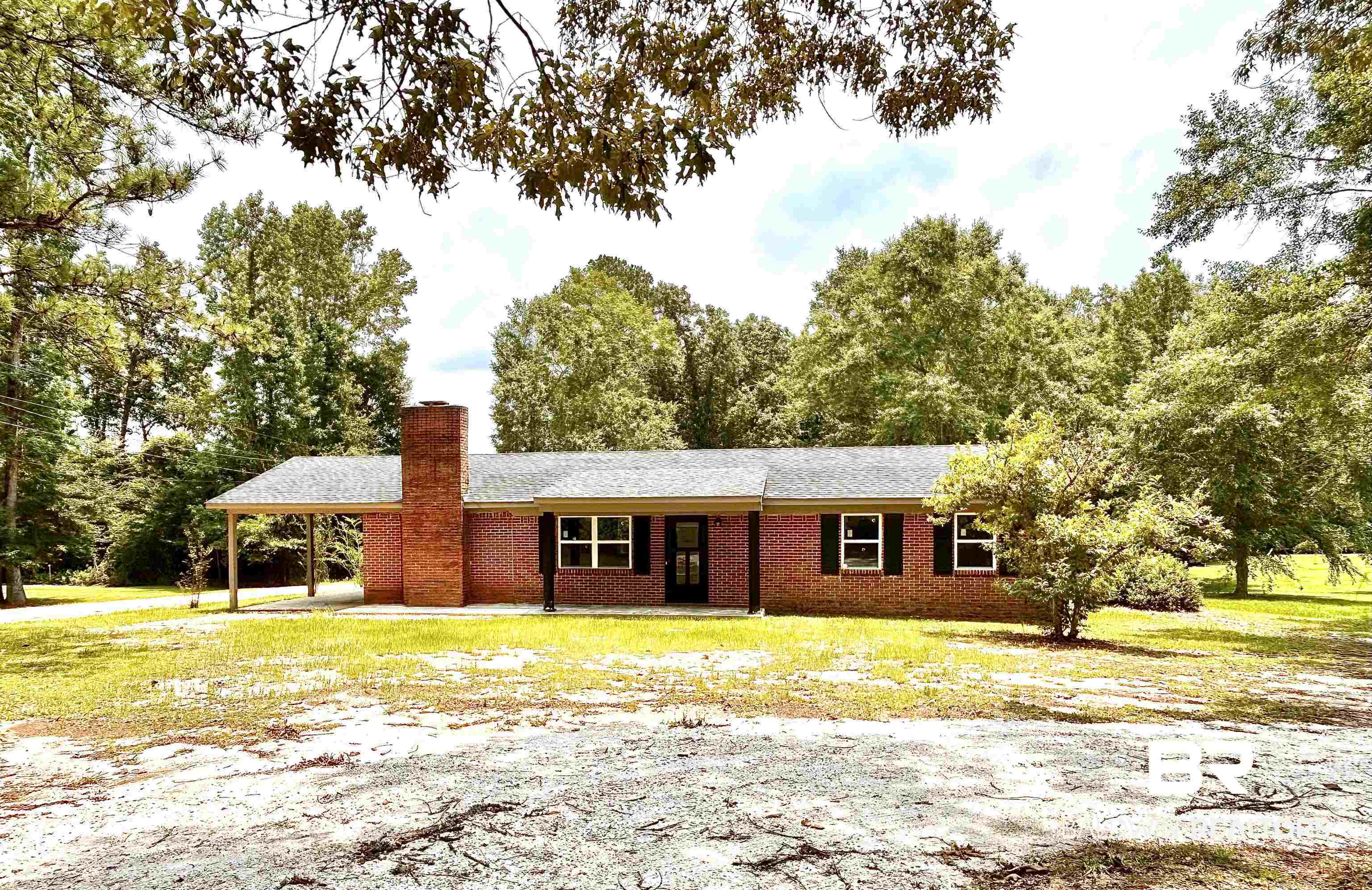 7870 Bradley Road Brewton, AL 36426 - Photo 1 of 8 Brick exterior residence featuring a visible chimney structure