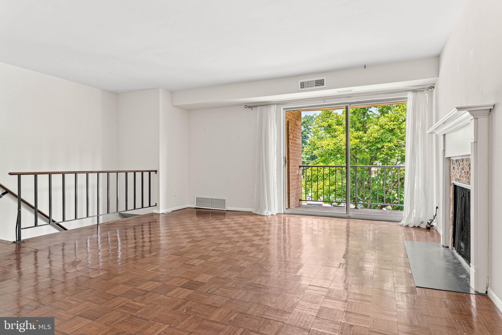 423 Old Forge Crossing, Unit 423 Devon, PA 19333 - Photo 3 of 24 Living Room w/ sunny balcony