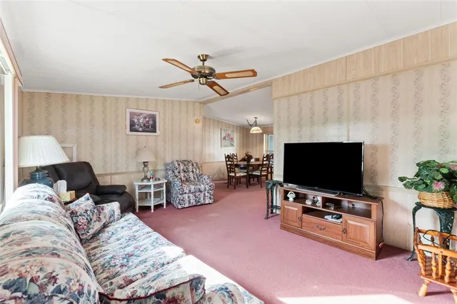a view of a room with furniture and large windows