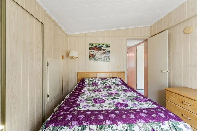 a bedroom with a bed and a television