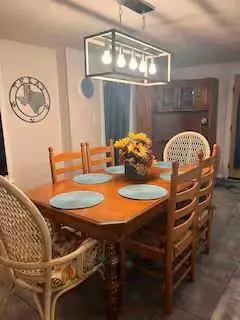 a dining room with furniture and a chandelier