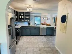 a kitchen with stainless steel appliances granite countertop a refrigerator and a stove