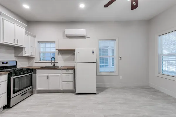 a kitchen with stainless steel appliances granite countertop a stove a sink and a refrigerator