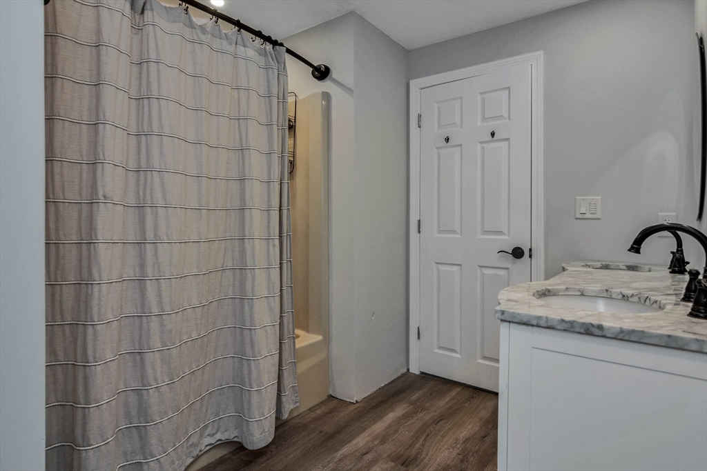 110 Harper Ridge Road Hampstead, NH 03826 - Photo 11 of 32 a bathroom with a granite countertop sink a mirror and shower