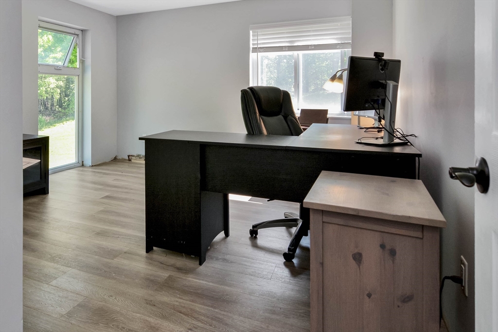 110 Harper Ridge Road Hampstead, NH 03826 - Photo 12 of 32 a view of a workspace with furniture and wooden floor
