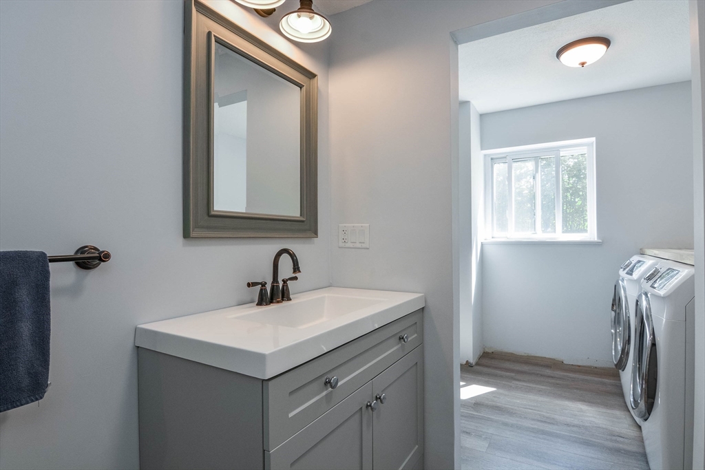 110 Harper Ridge Road Hampstead, NH 03826 - Photo 18 of 32 a bathroom with a sink vanity and a mirror