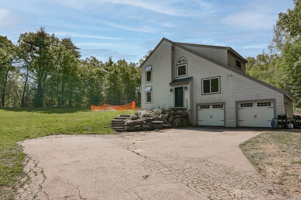 110 Harper Ridge Road Hampstead, NH 03826 - Photo 29 of 32 a front view of house with yard and green space