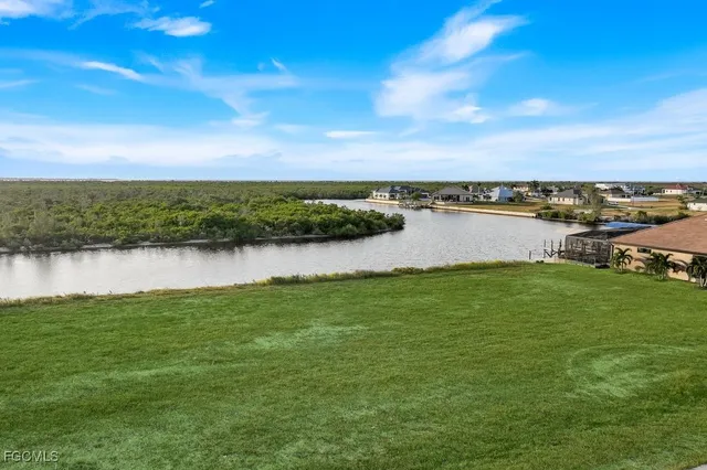 a view of a lake with houses in the back