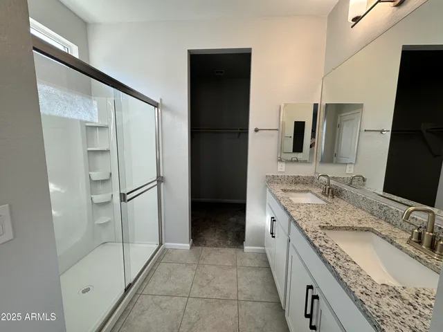 a large bathroom with a granite countertop sink and a mirror