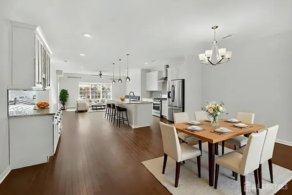 a view of a dining room with furniture and wooden floor