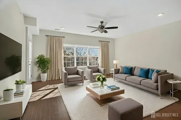 a living room with furniture and a flat screen tv