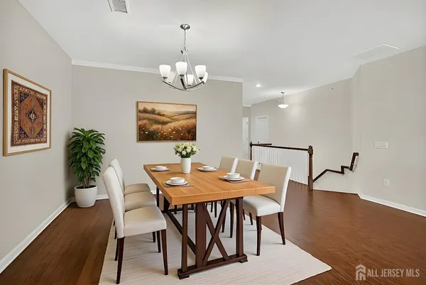 a view of a dining room with furniture wooden floor and a chandelier