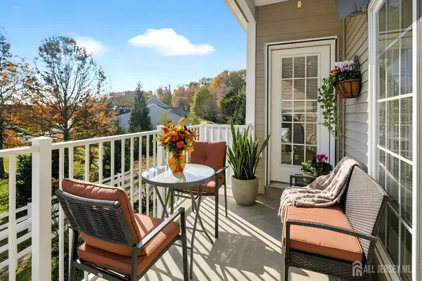 a view of a patio with a dining table and chairs with wooden floor