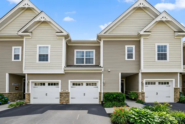 a view of a white building with large windows