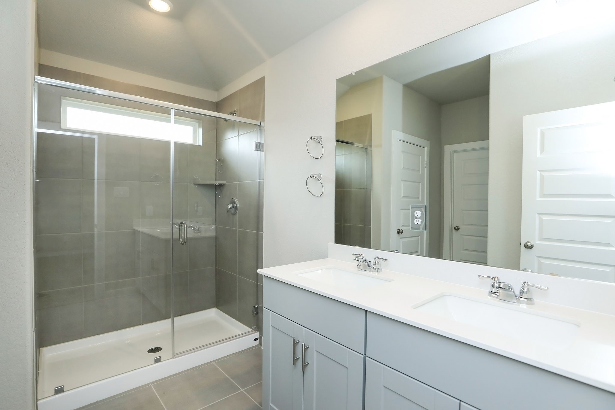 14110 Greystone Ter Street Magnolia, TX 77354 - Photo 10 of 34 The Primary Bath Offers An Oversized Walk-In Shower, Dual Sinks, Quartz Counters, And A Large Linen Closet. The Same Shaker Cabinetry And Pulls Are Carried Over From The Kitchen Giving The Home A Wonderfully Consistent Flow.