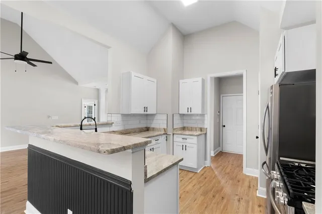 a kitchen with a sink stove and refrigerator