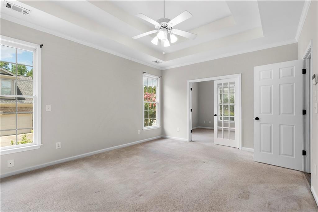 65 Riverwood View Dallas, GA 30157 - Photo 7 of 11 an empty room with windows and ceiling fan