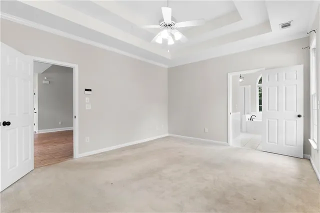 an empty room with fan and entrance