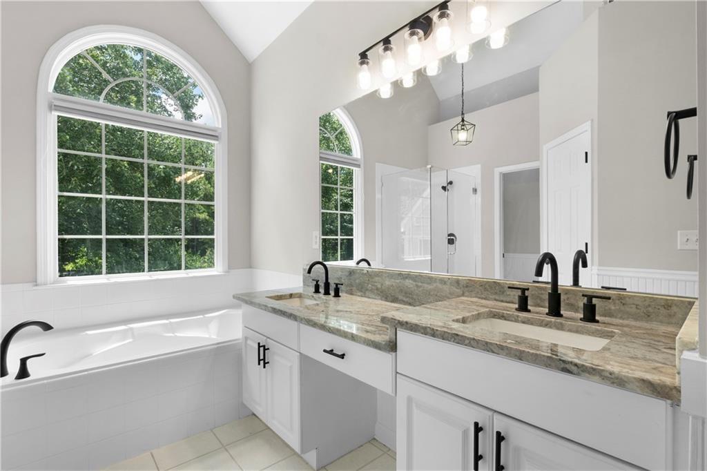 65 Riverwood View Dallas, GA 30157 - Photo 9 of 11 a bathroom with sinks mirror and a bathtub