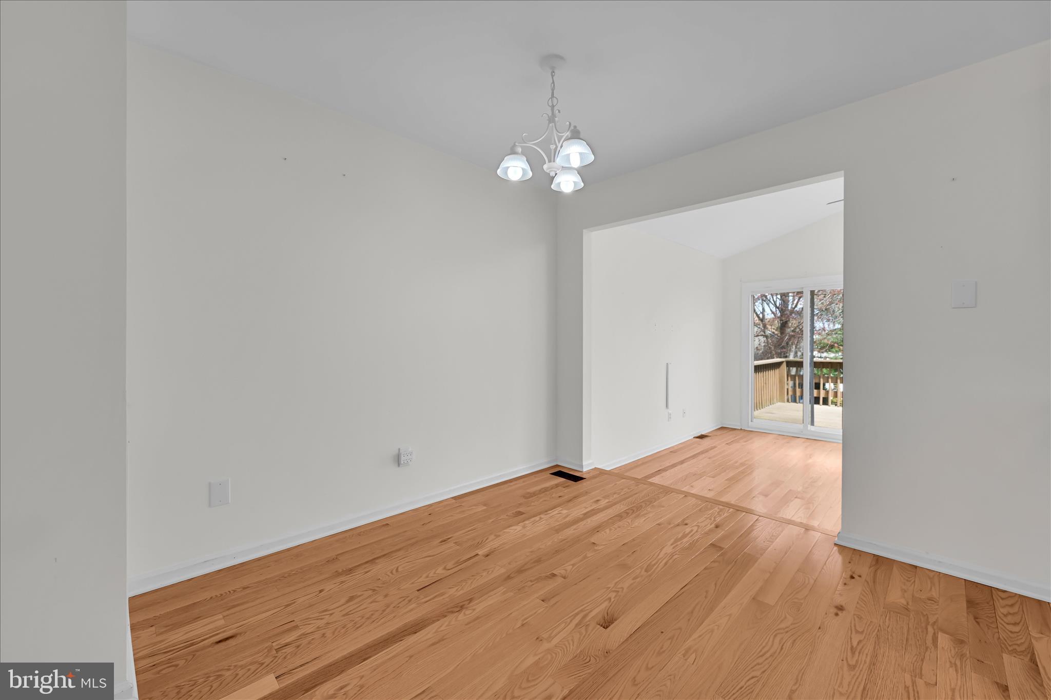 169 Judy Way Aston, PA 19014 - Photo 11 of 43 a view of an empty room with chandelier fan and wooden floor