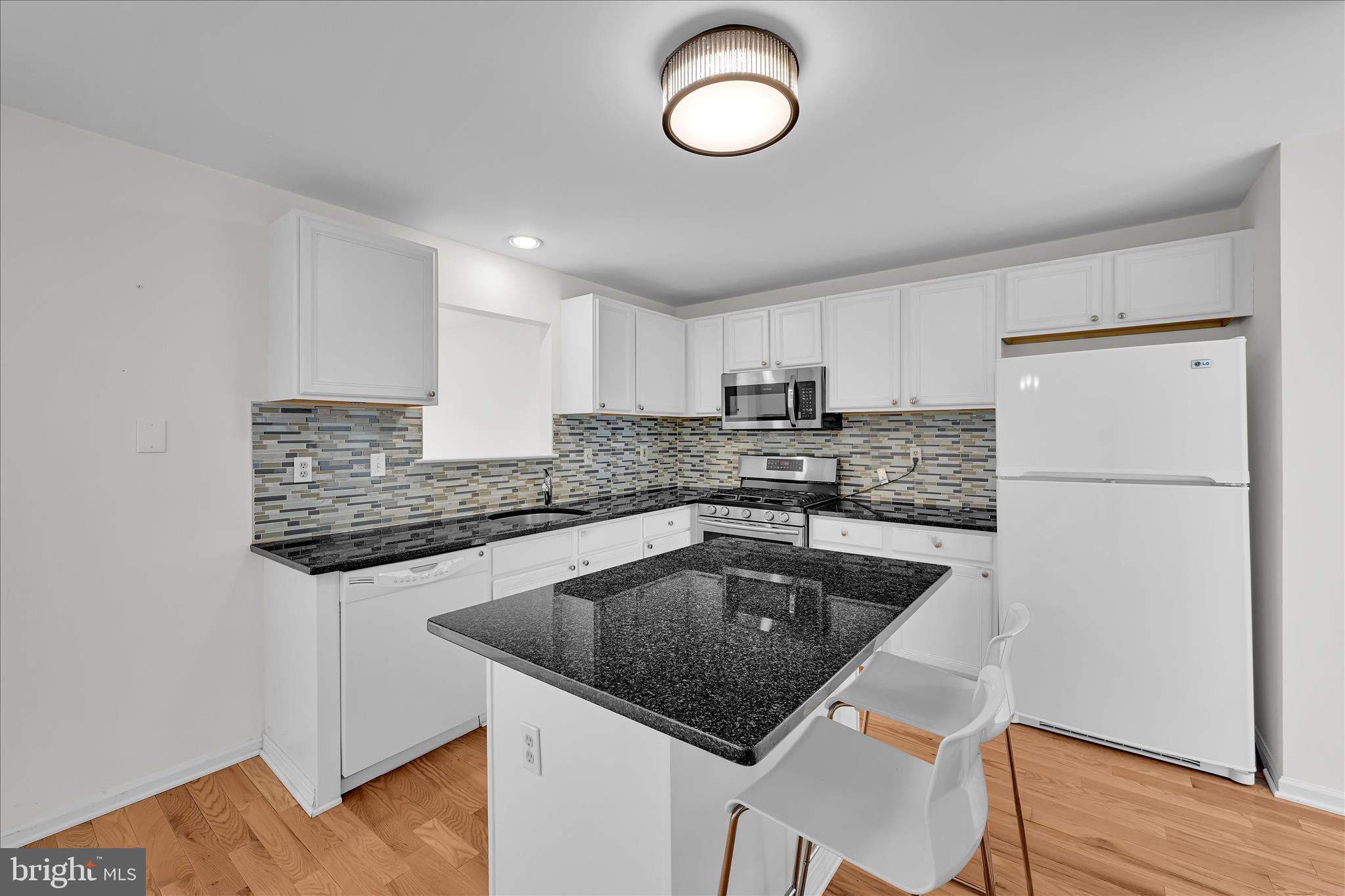 169 Judy Way Aston, PA 19014 - Photo 12 of 43 a kitchen with granite countertop a sink and a refrigerator