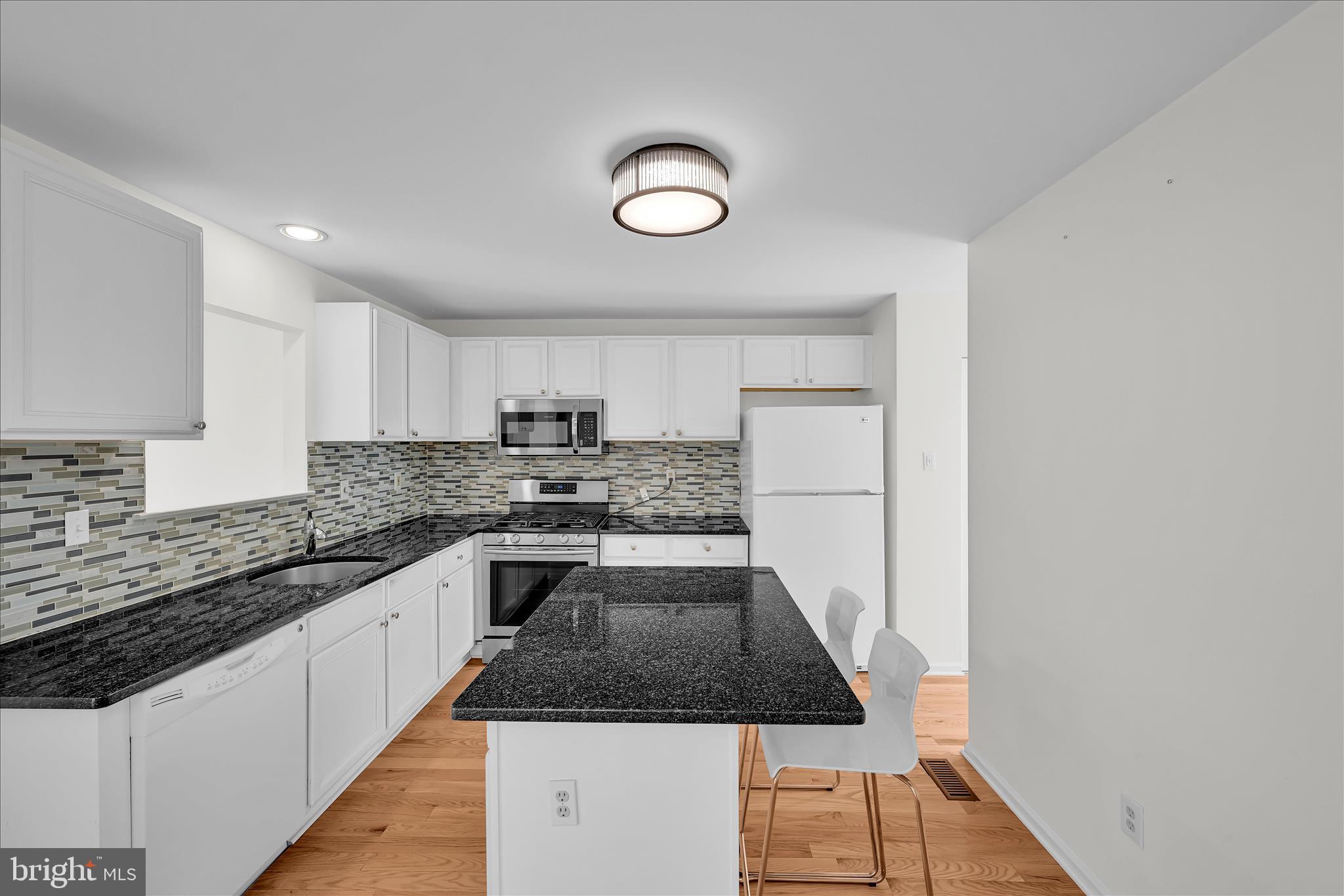 169 Judy Way Aston, PA 19014 - Photo 13 of 43 a kitchen with granite countertop a stove and a sink