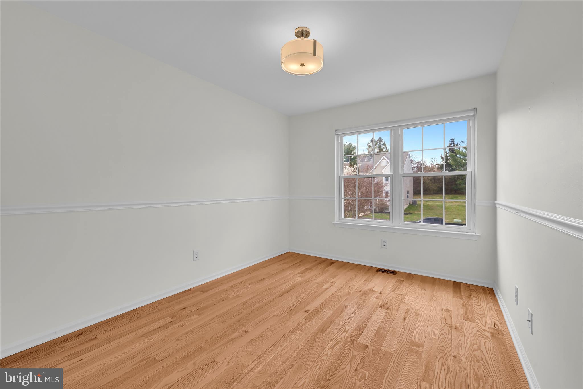 169 Judy Way Aston, PA 19014 - Photo 25 of 43 a view of an empty room with wooden floor and a window