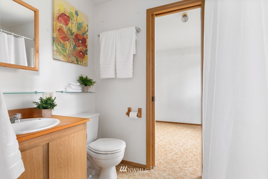 3769 Periwinkle Road Clinton, WA 98236 - Photo 14 of 29 a bathroom with a toilet and a sink