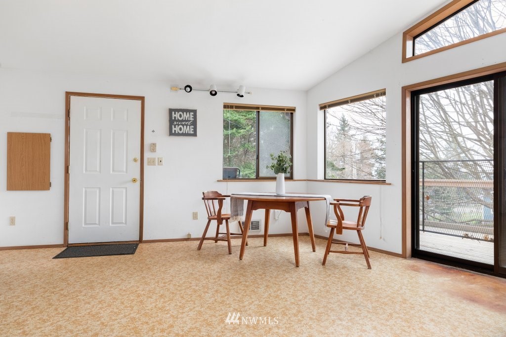 3769 Periwinkle Road Clinton, WA 98236 - Photo 5 of 29 a dining room with furniture and a large window
