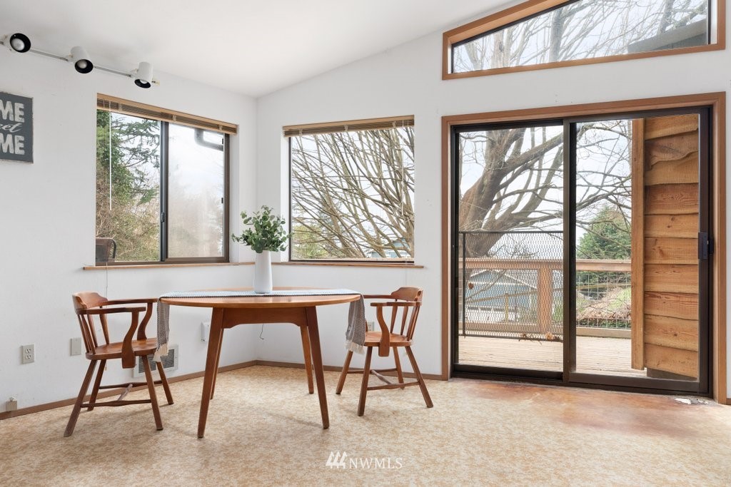 3769 Periwinkle Road Clinton, WA 98236 - Photo 6 of 29 a dining room with furniture and a window