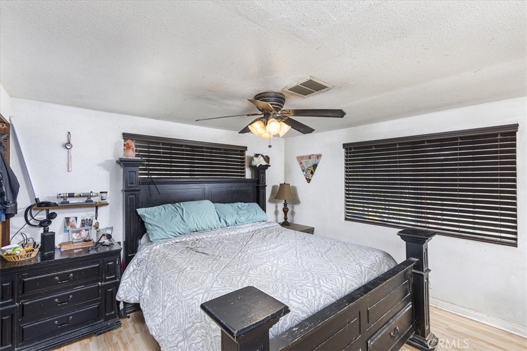 44000 Sandstone Road Aguanga, CA 92536 - Photo 12 of 31 a bedroom with a bed and a chandelier