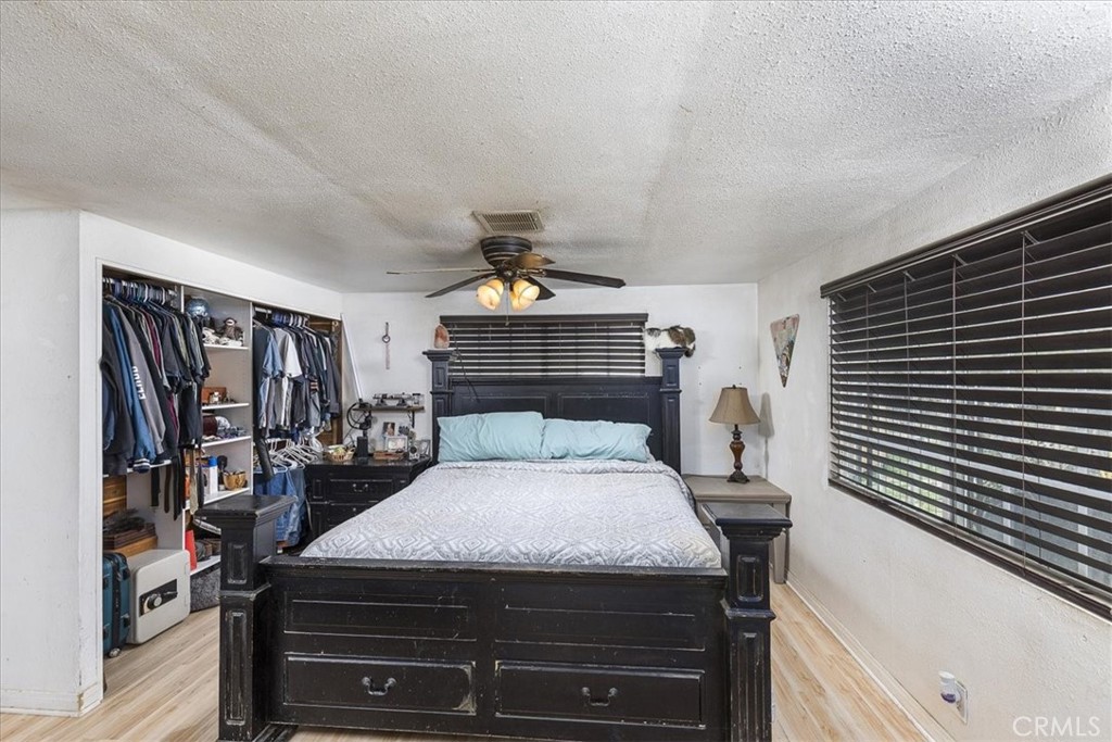44000 Sandstone Road Aguanga, CA 92536 - Photo 13 of 31 a bedroom with a bed and walk in closet