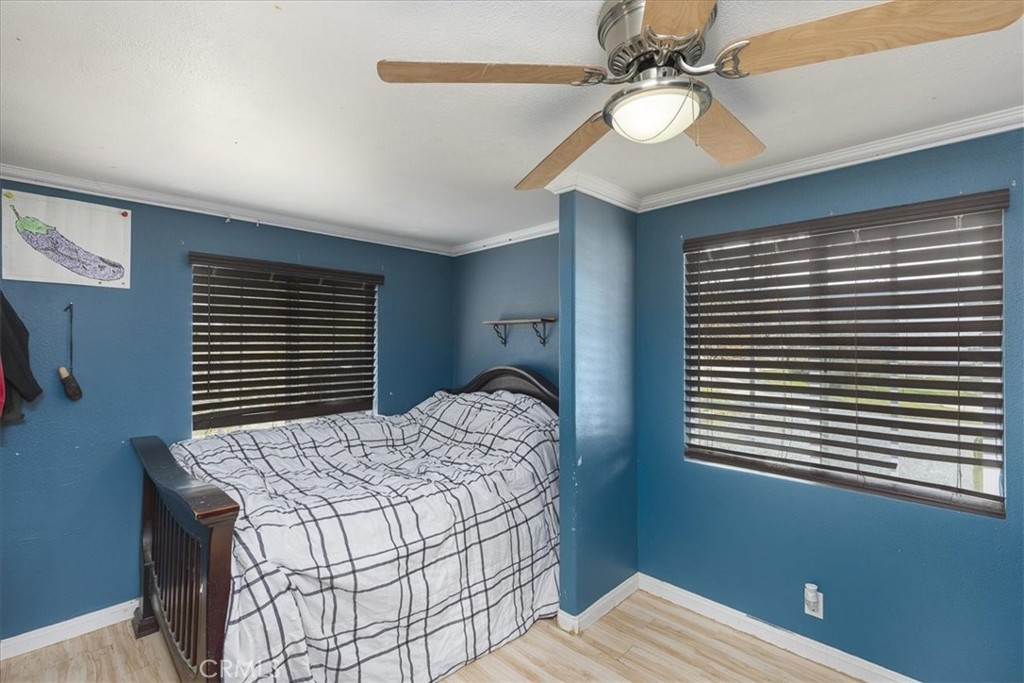 44000 Sandstone Road Aguanga, CA 92536 - Photo 17 of 31 a bedroom with a bed and a chandelier